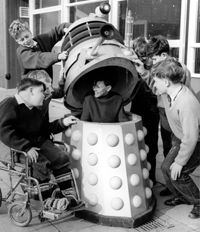 Children at the Warlies Dr. Barnardo's home play with one of their Daleks.