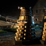The three Daleks pass the cannon