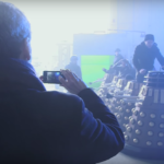 Peter Capaldi takes a picture while the six Daleks are readied.